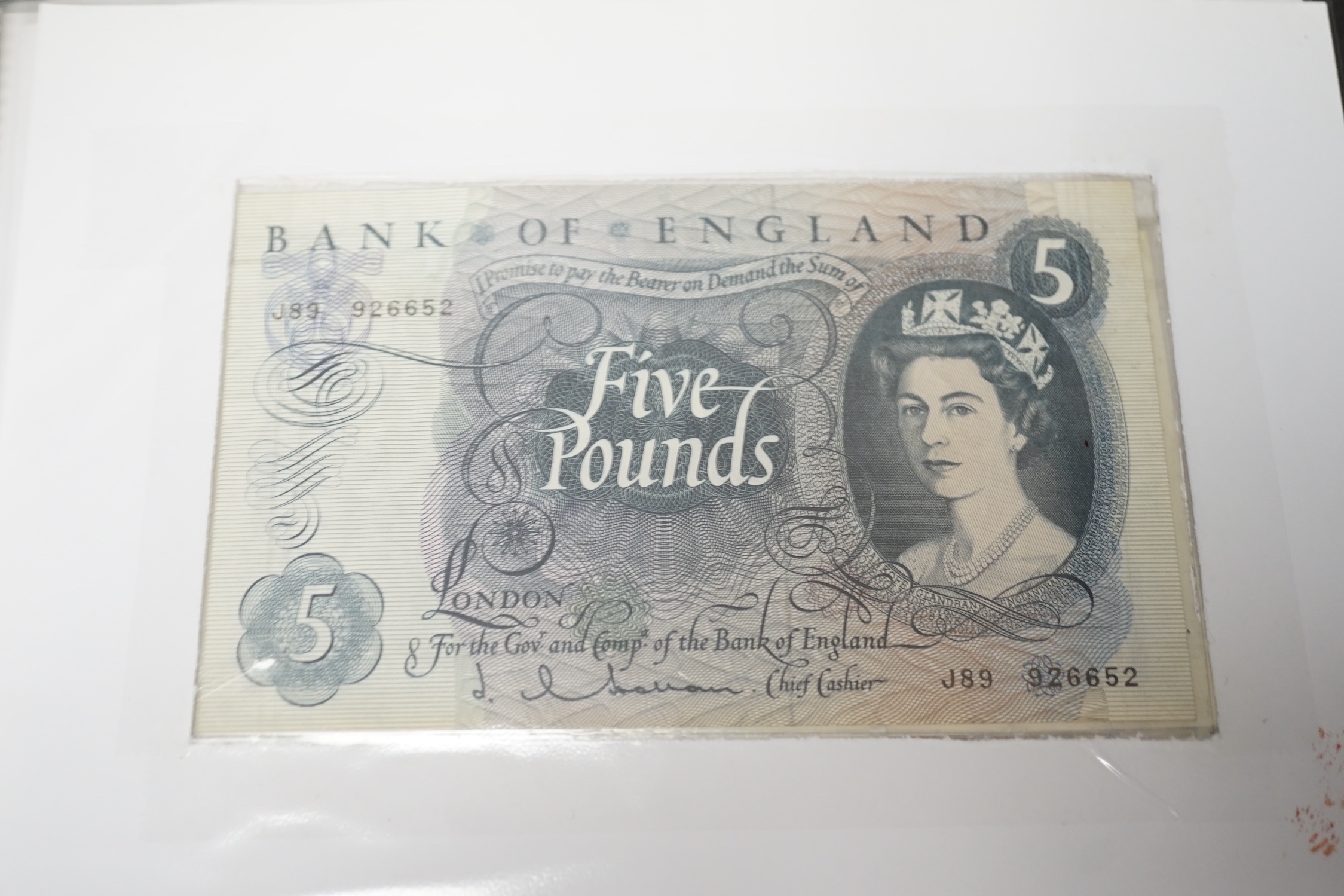 A collection of UK George V to Queen Elizabeth II banknotes, in an album
